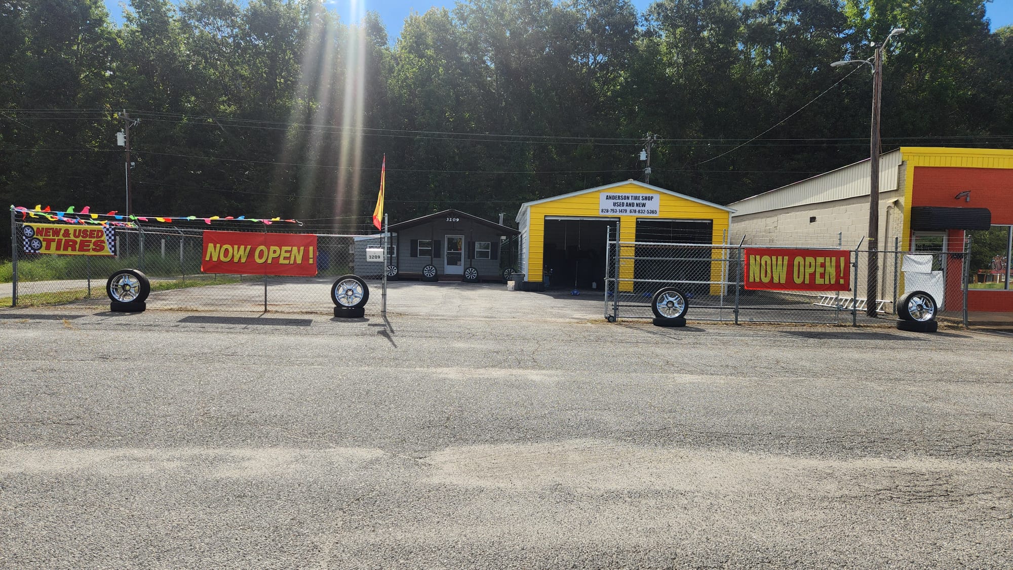 The lot on S Murray Ave with our yellow shop and Now Open banners