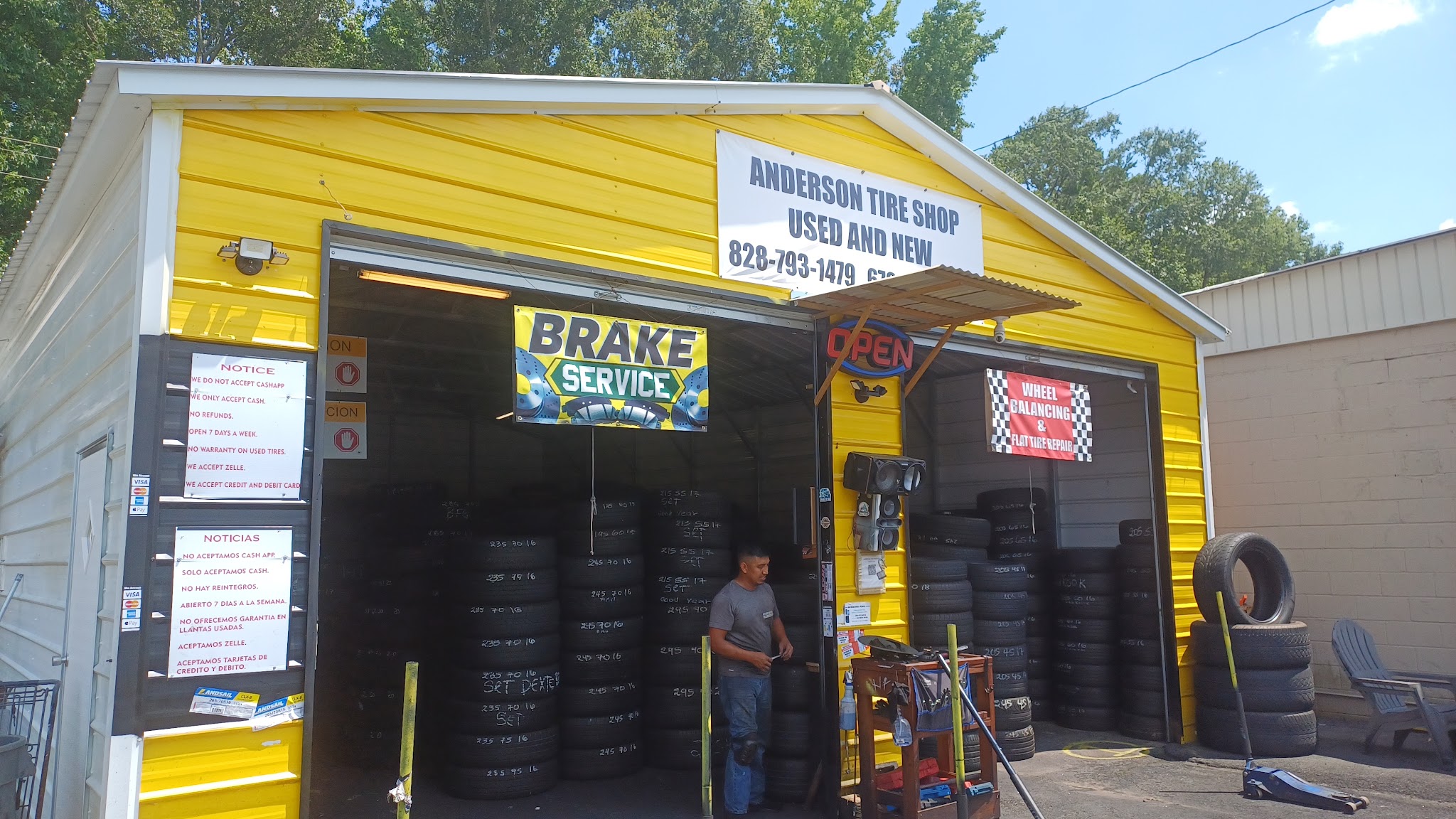 Our shop with the brake service banner and tires stacked inside
